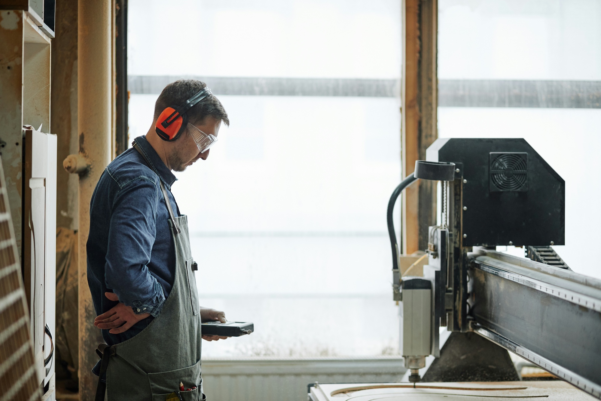 Craftsman working on a handmade wooden product in a workshop