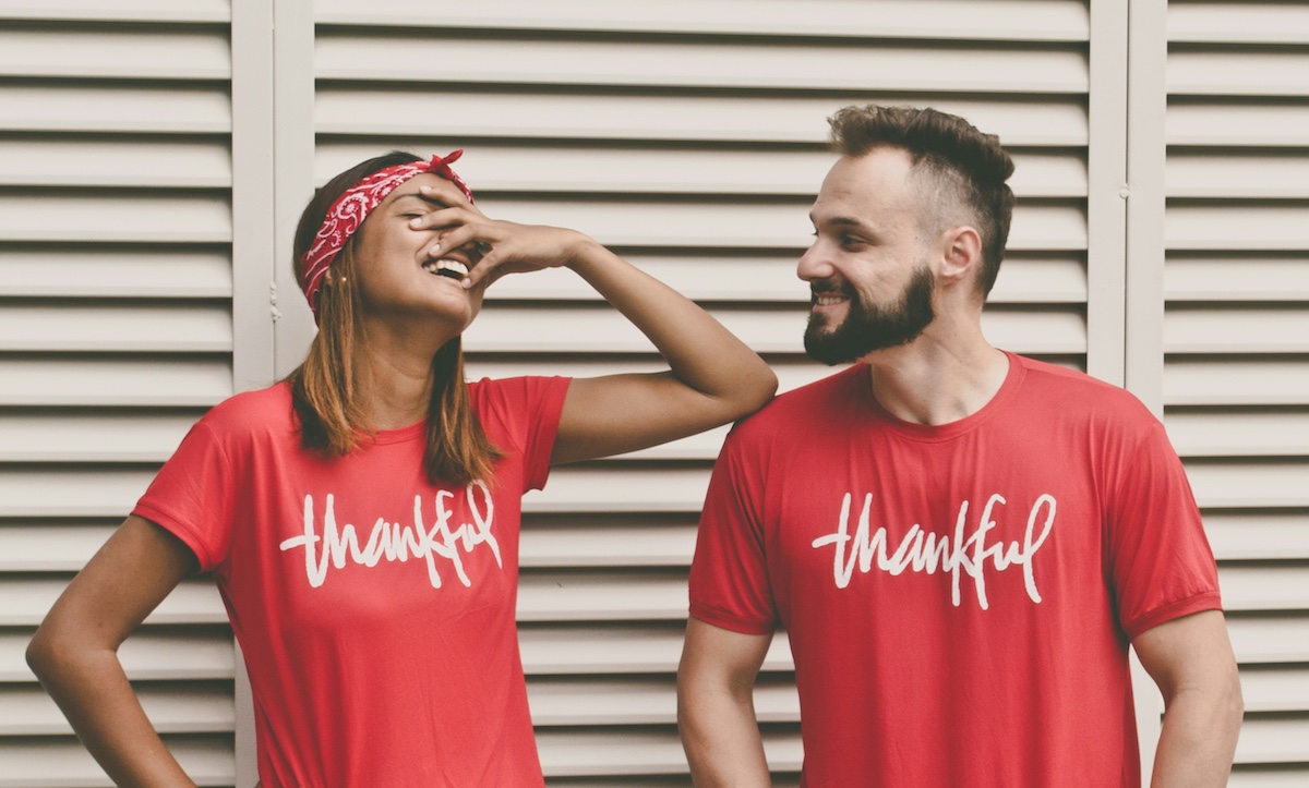 People laughing wearing the same t shirt